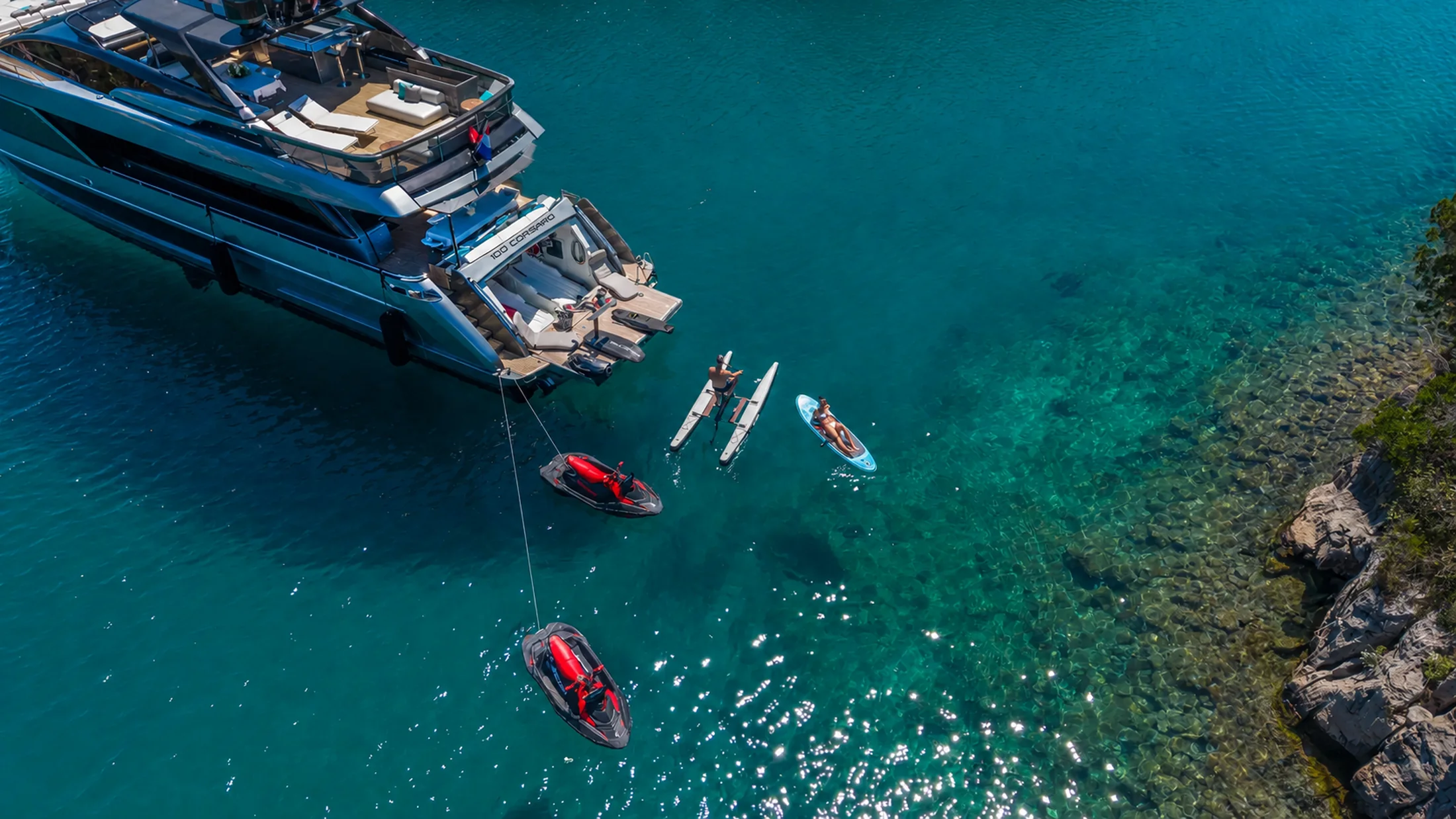 Paddleboards and water toys off the stern of YOYITA II