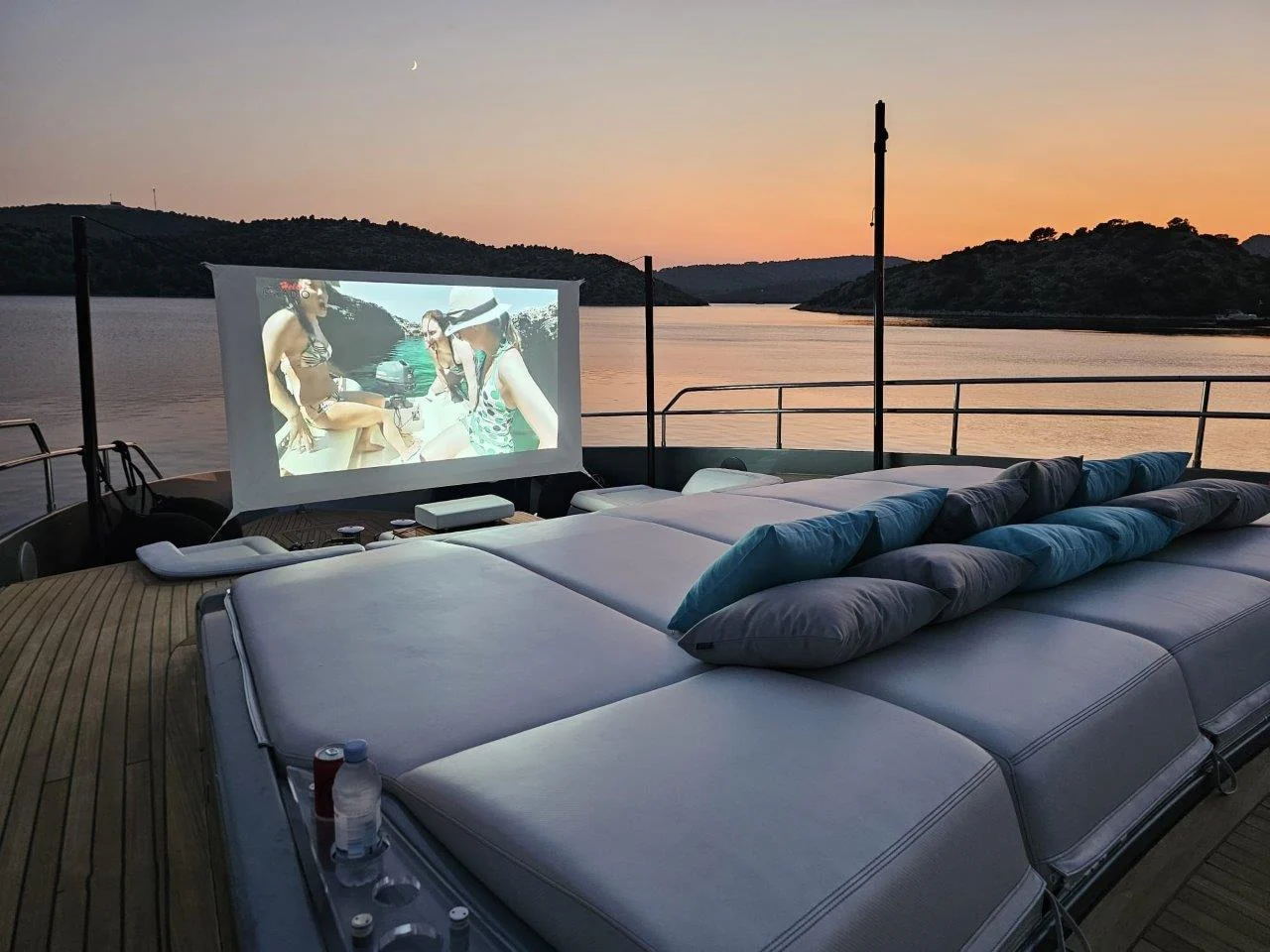 Open-air cinema on the upper deck of YOYITA II at sunset