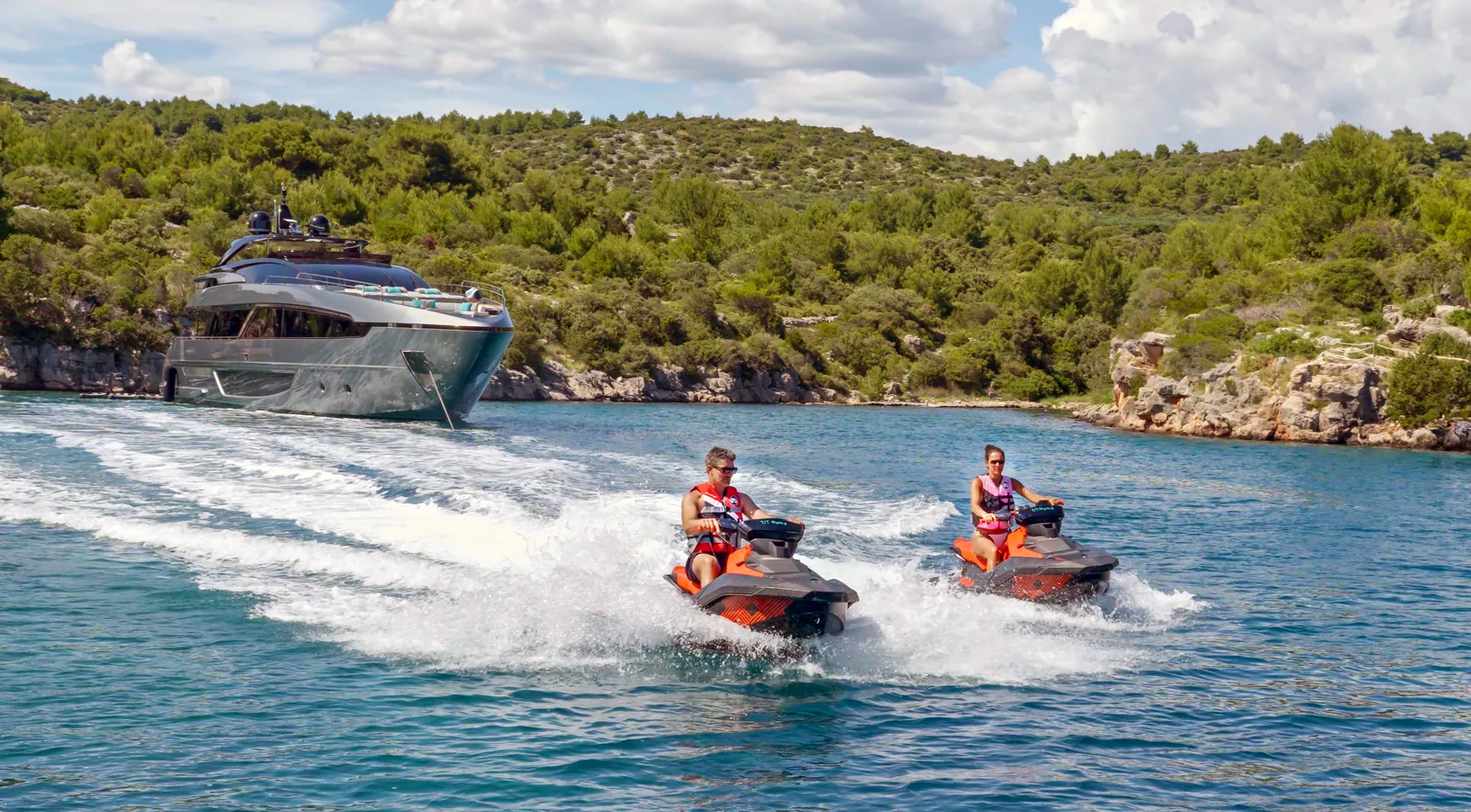 Jet skis running alongside YOYITA II